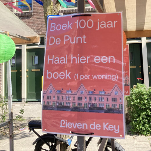 Poster met de tekst: Boek 100 jaar De Punt. Haal hier een boek (1 per woning)